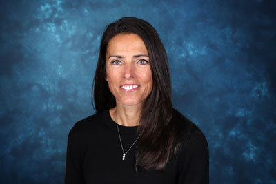 profile image of Kelly Higgins in front of a blue background
