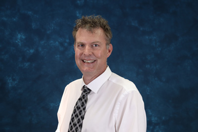 profile image of Scott Schonewolf in front of a blue background