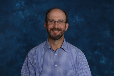 profile image of Tom Cerny in front of a blue background