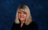 profile image of Lisa Uffelman in front of a blue background