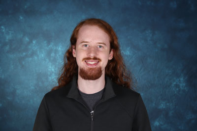 profile image of Alex Troue in front of a blue background